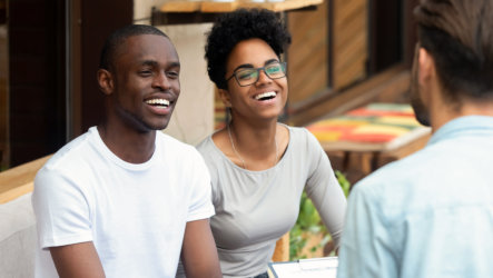 couple happily talking to a counselor